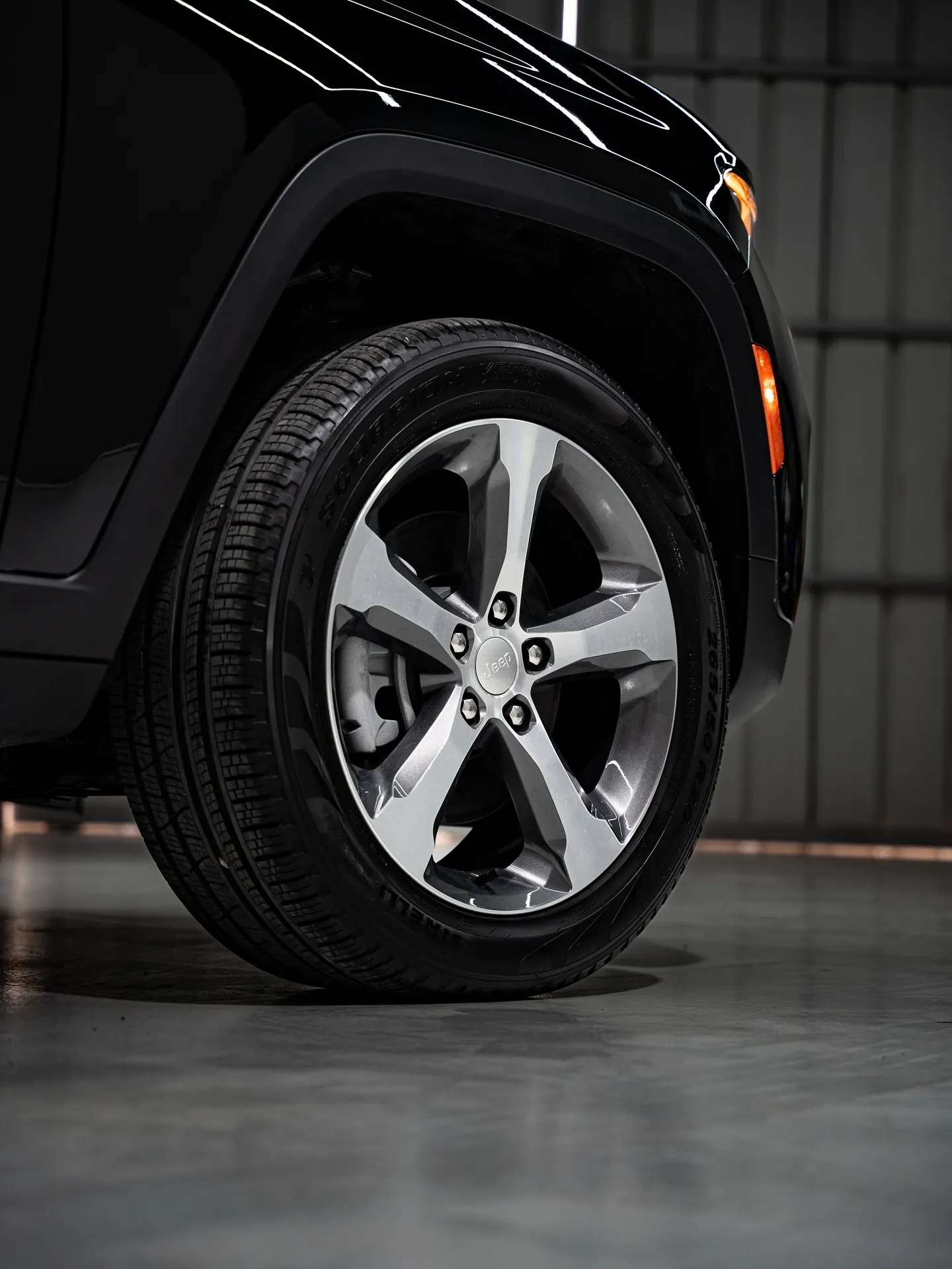The alloy wheel and wheel arch of a black SUV, photographed close