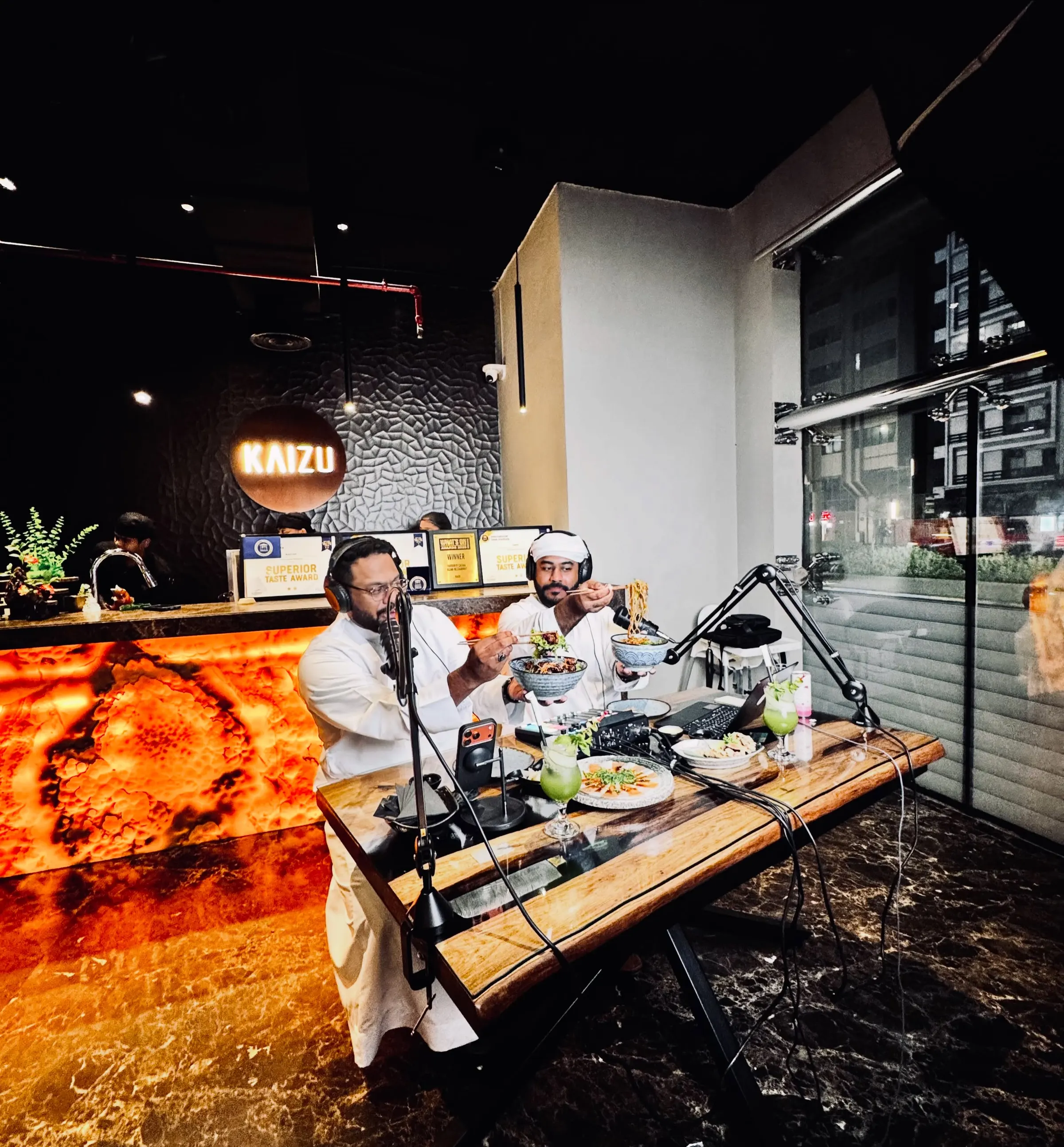 A podcast recorded inside a restaurant, wide of the set