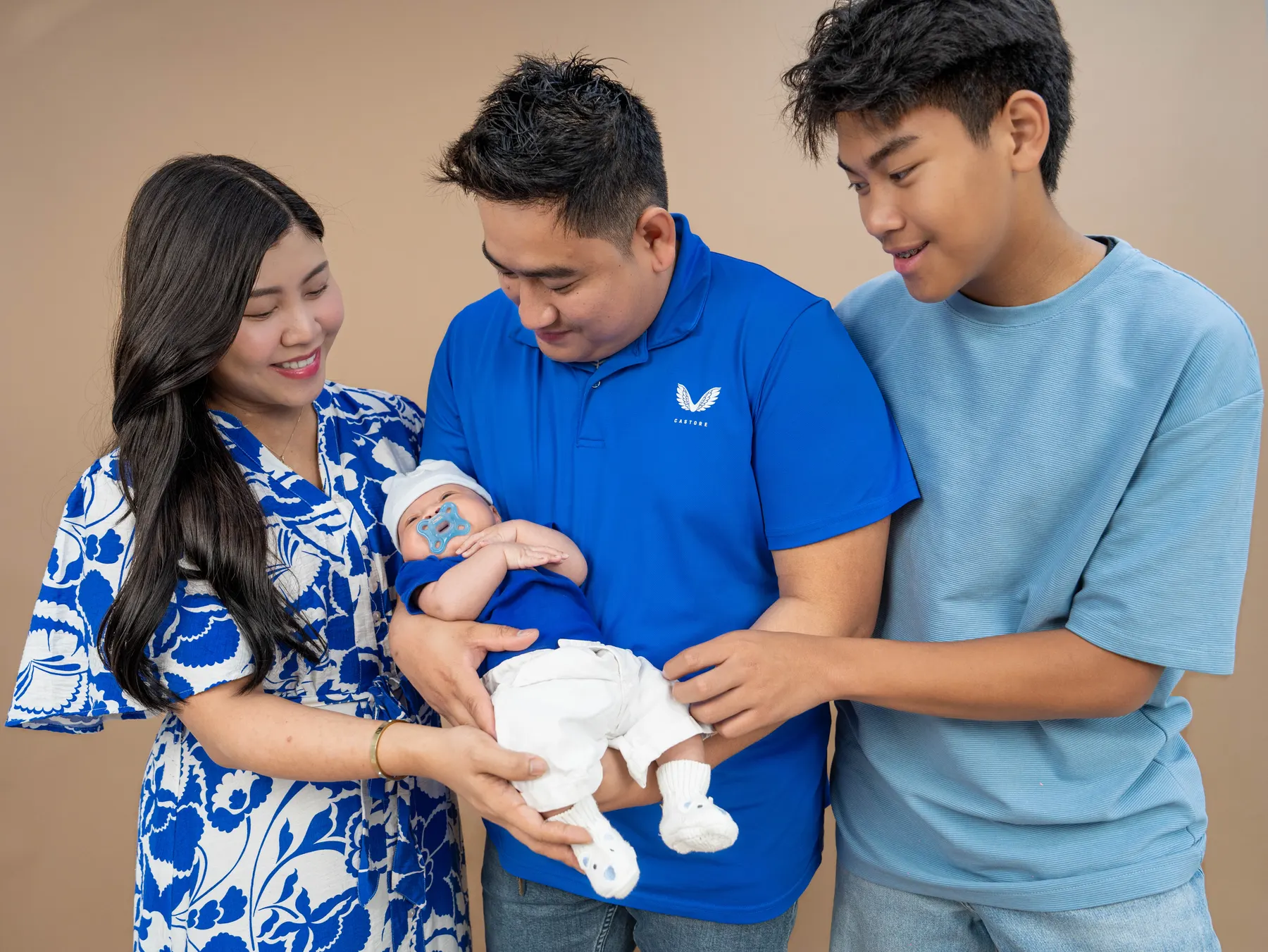 Family group portrait with a newborn baby