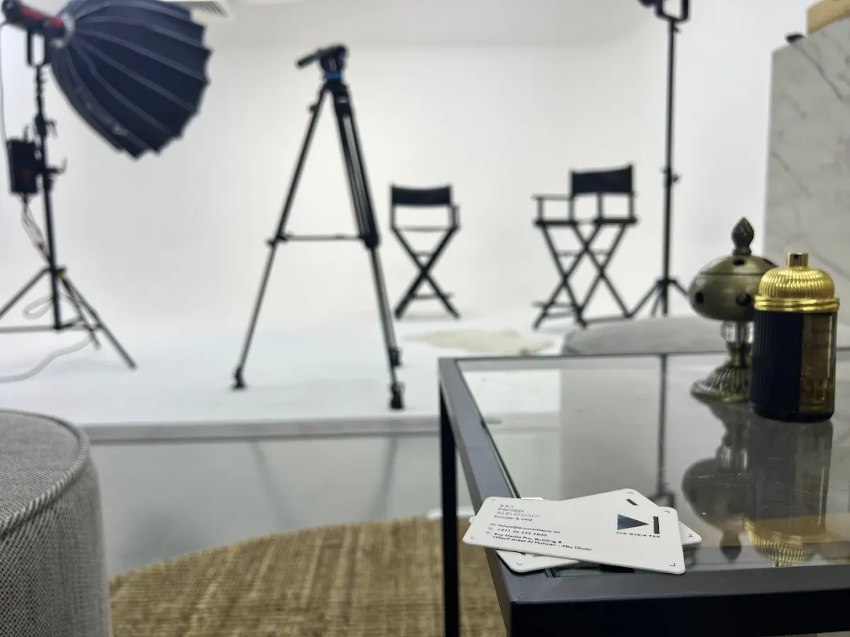 Shallow-focus view of studio lighting stands and director's chairs