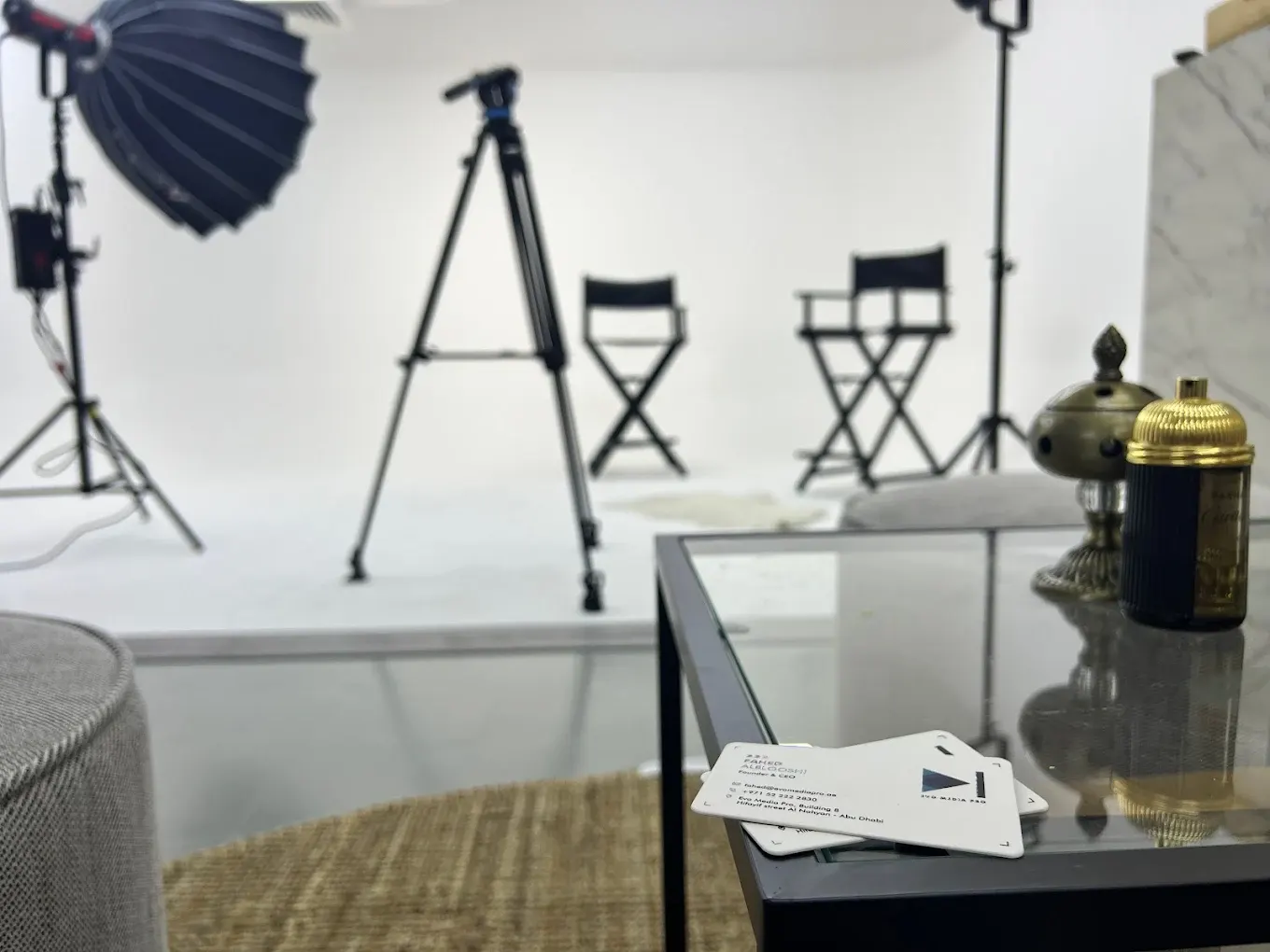 Shallow-focus view of studio lighting stands and director's chairs