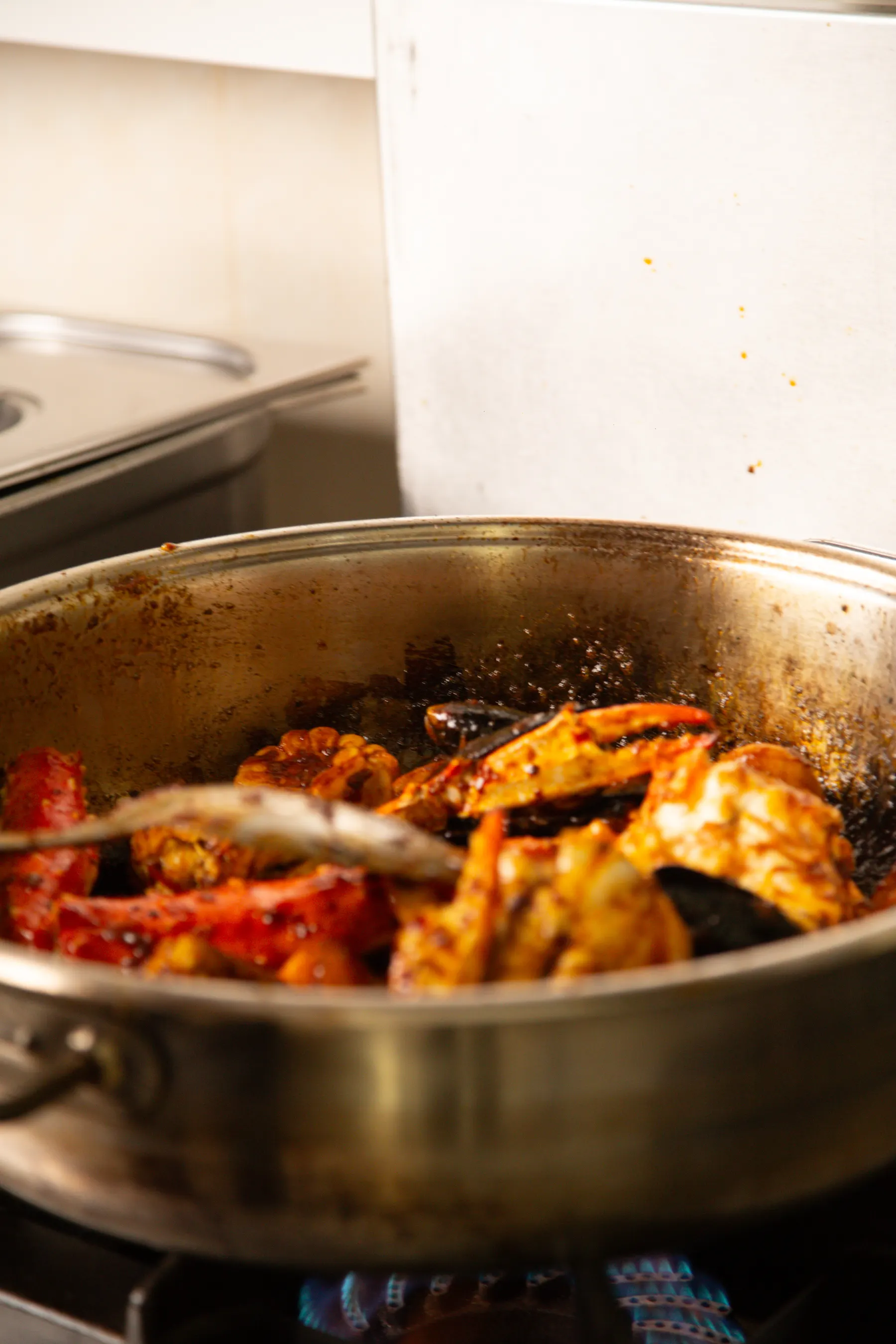 Seafood and spices cooking in a copper pan
