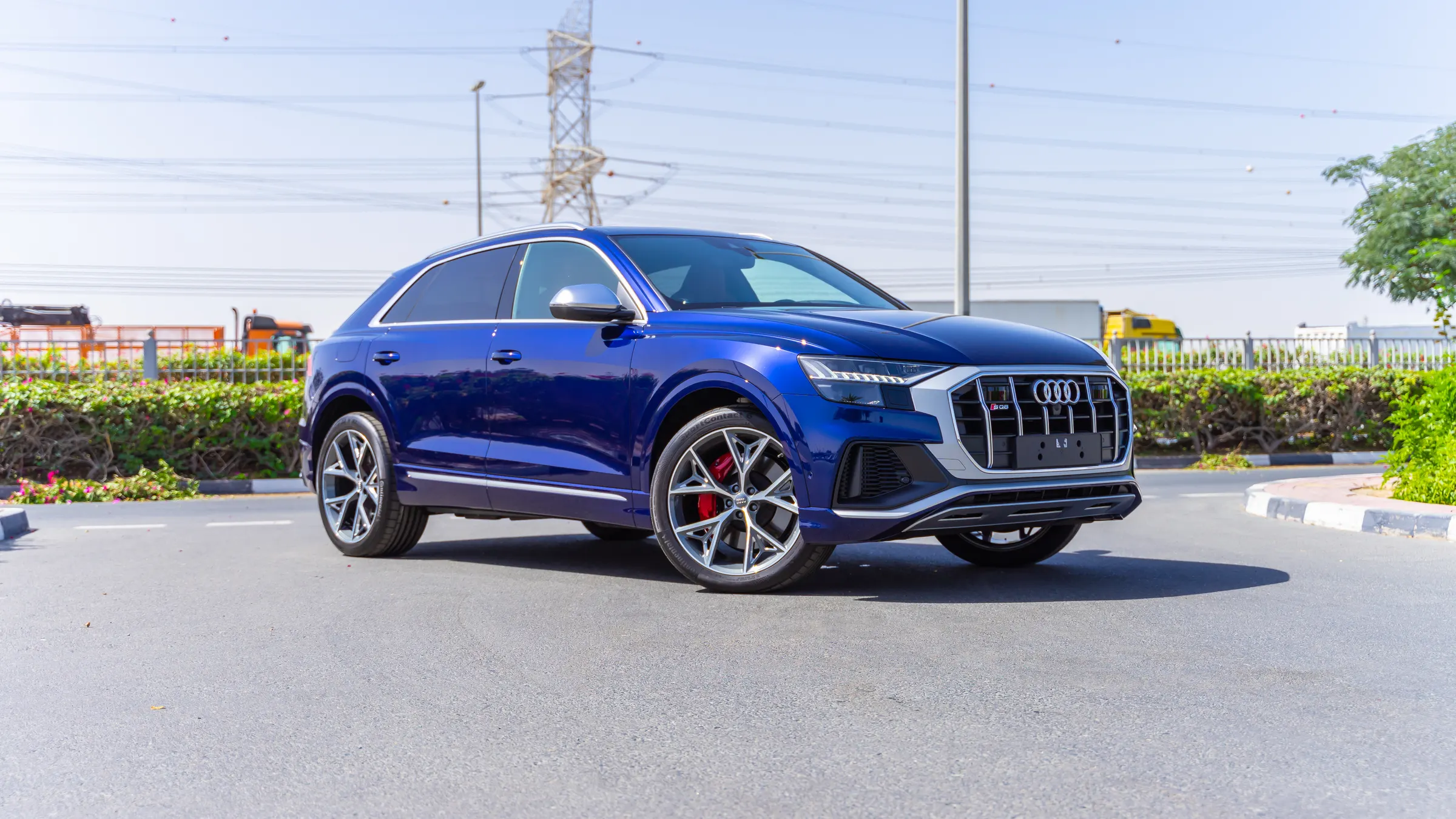 Blue performance SUV photographed from a three-quarter angle at the roadside